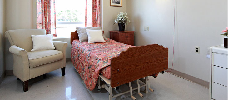 the bedroom with bed and armchair